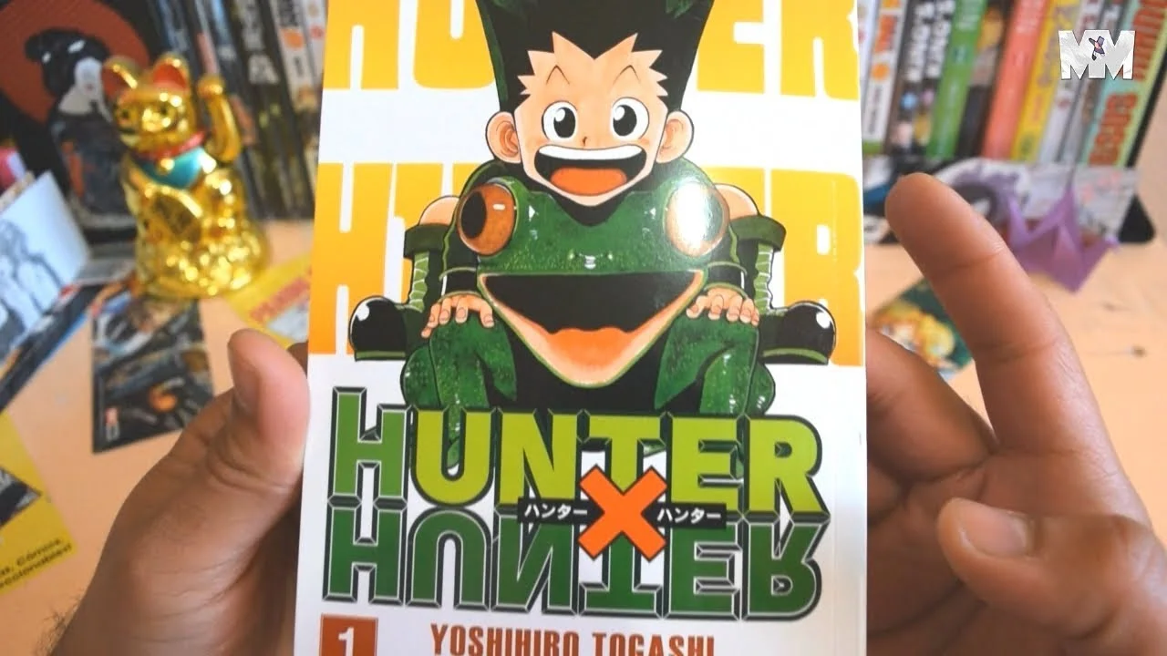 volumen 1 del manga Hunter x Hunter de Yoshihiro Togashi, con la portada que muestra a Gon Freecss sonriendo sobre un sapo gigante verde, fondo amarillo con el título en letras verdes y naranjas