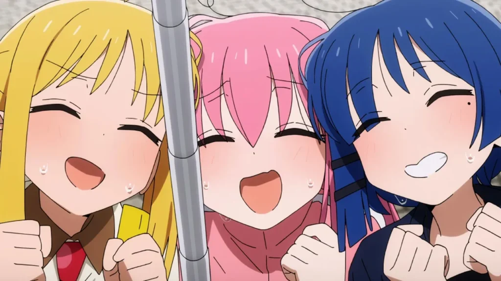 Ikuyo Kita, Hitori Gotoh y Ryō Yamada de la Kessoku Band celebrando juntas en Bocchi the Rock!