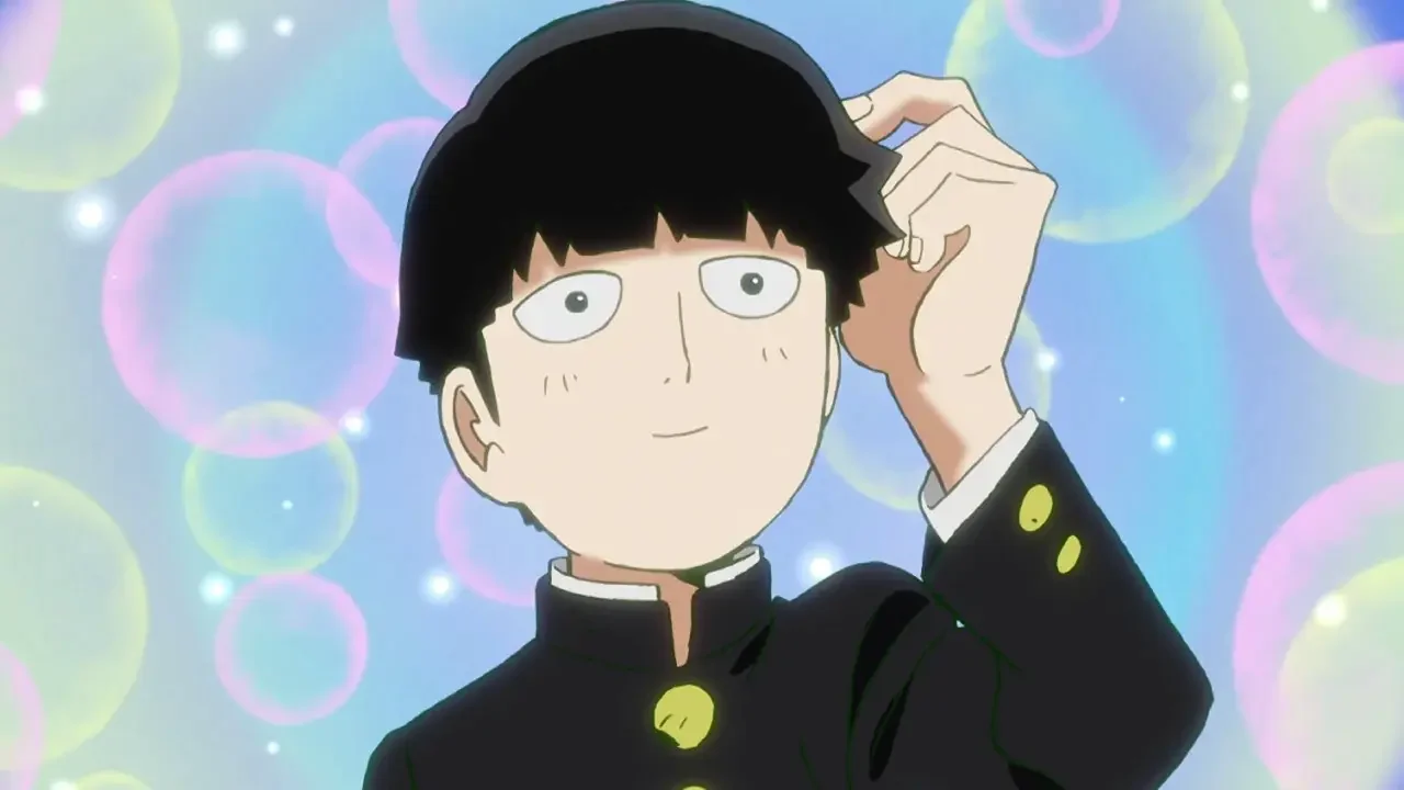 Mob con expresión tímida rodeado de burbujas de colores en Mob Psycho 100