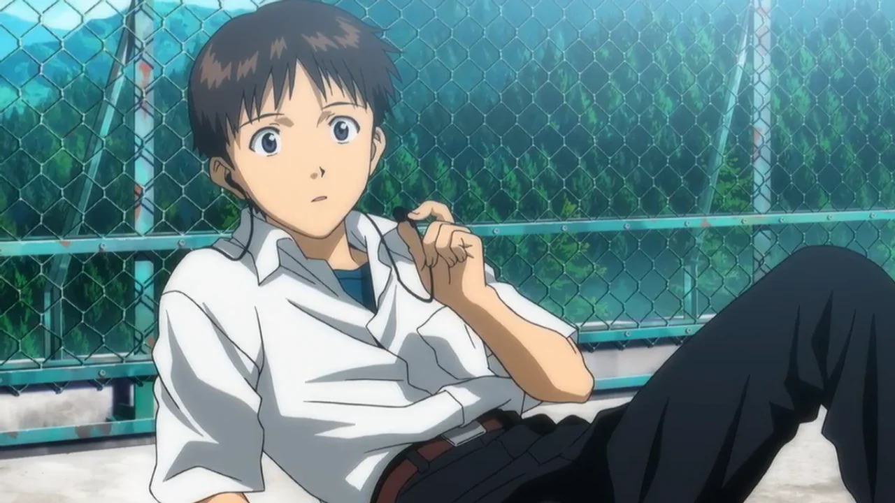 Shinji Ikari sentado solo en Neon Genesis Evangelion, reflejo del aislamiento emocional del personaje